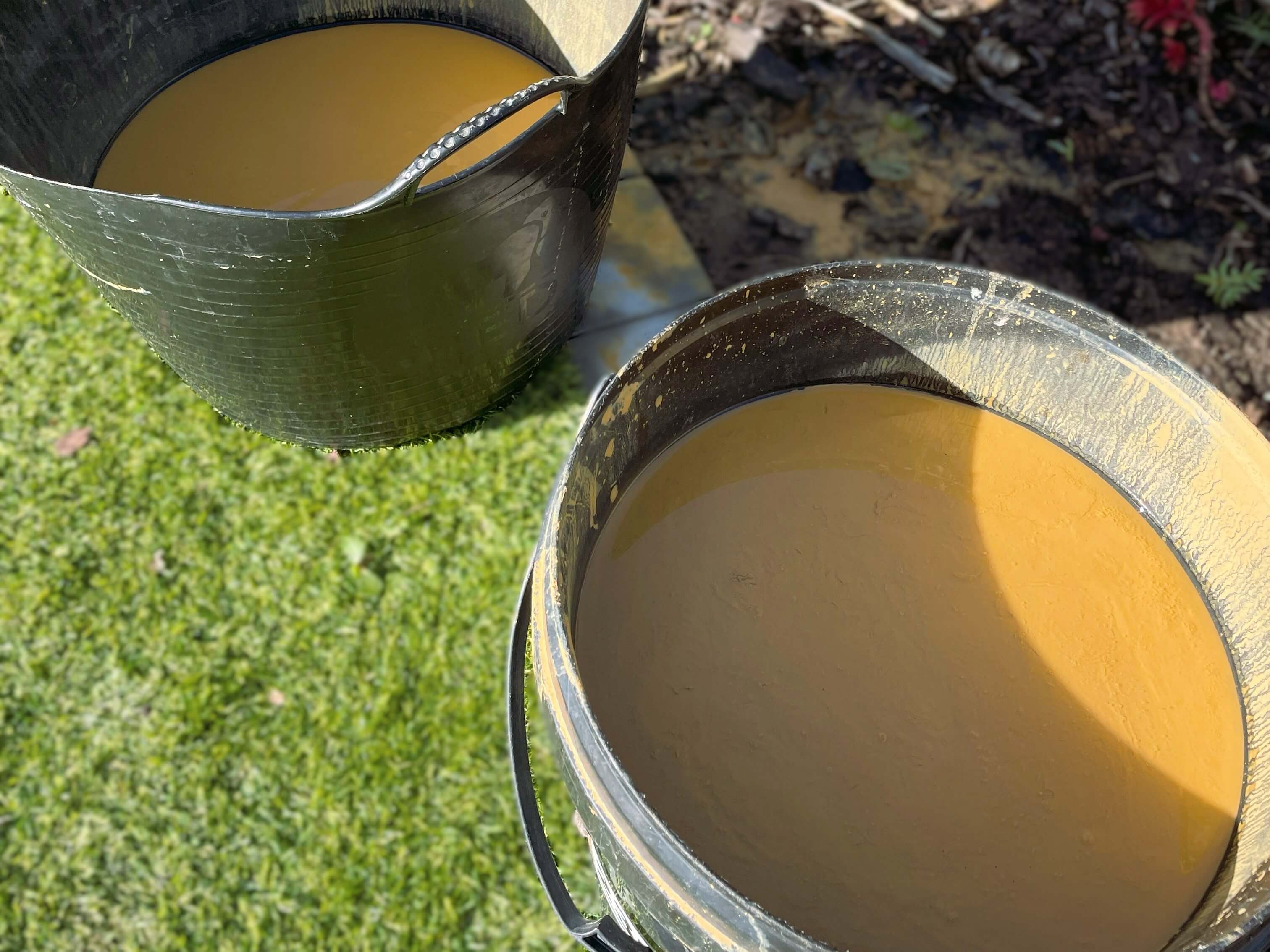 buckets of clay in water to make ollas at home